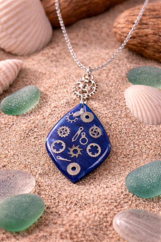 Deep-blue pendant with metallic gear-like elements Necklace
