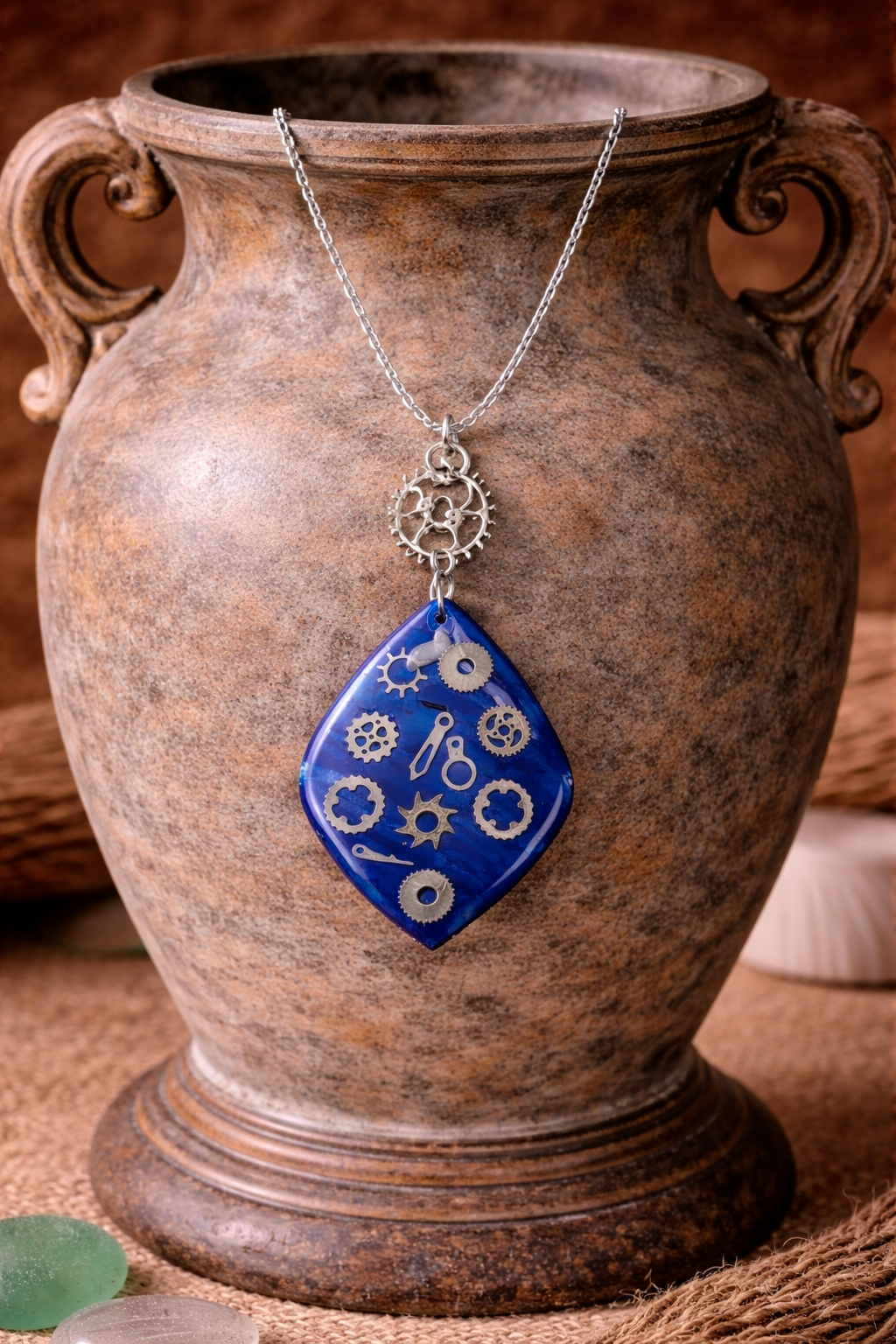 Deep-blue pendant with metallic gear-like elements Necklace