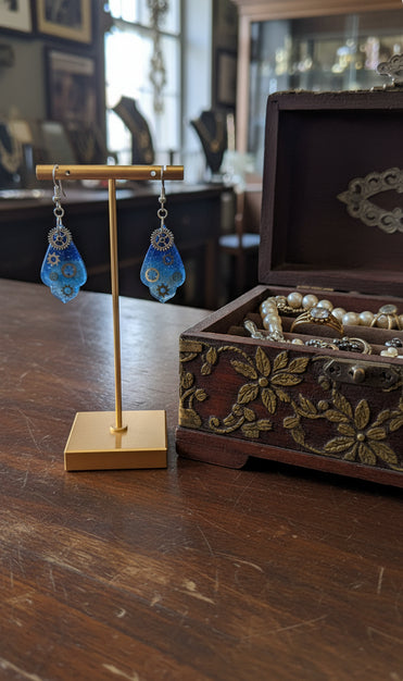 Softly pointed petal-like Earrings with gear charms