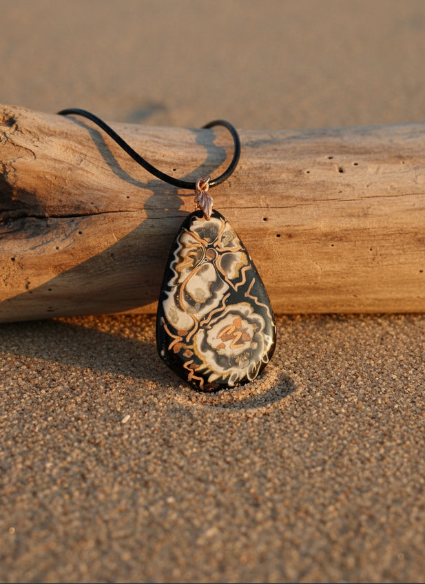 Deep blacks cradle warm golds Necklace