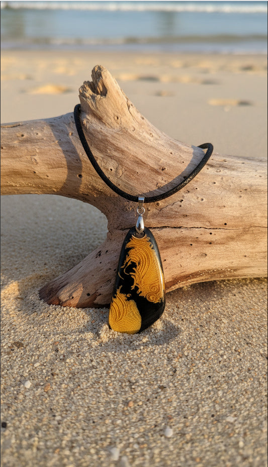 Warm golden tones ripple across black background Necklace